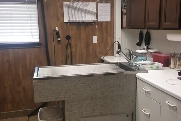 A exam and treatment room. Pictured is the exam table, and storage cabinets
